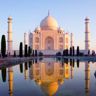 Earle morning view of Taj Mahal reflected in  water pond.