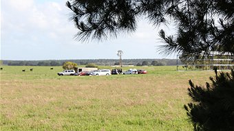 Police gather outside Tank cave on Sunday afternoon
